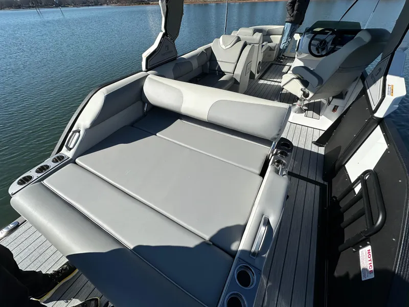 Slide: The Image of 2025 Montara Surf Boss 2.0 25 boat interior with gray seating and steering console. - 8