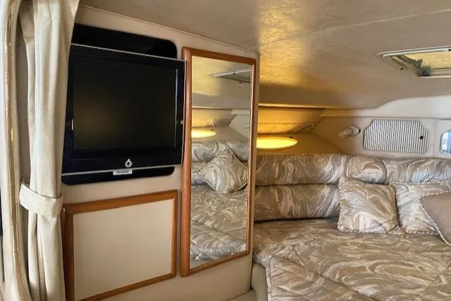 Slide: The Image of Interior of 1998 Sea Ray 330 Sundancer with TV, mirror, and patterned bedding. - 5