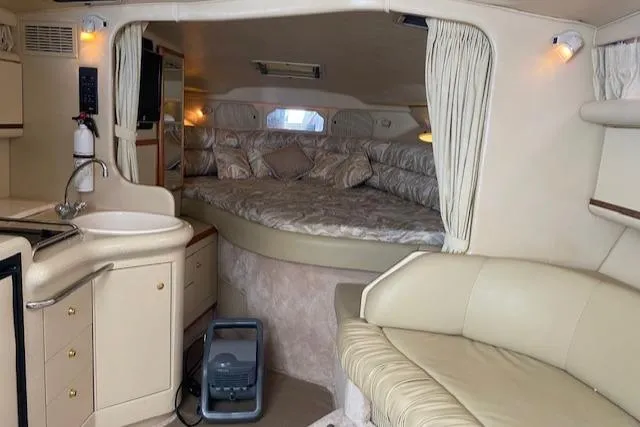 Slide: The Image of Interior of 1998 Sea Ray 330 Sundancer yacht with cozy bed and seating area. - 8