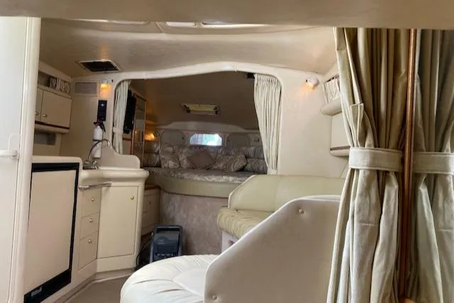Slide: The Image of Interior of 1998 Sea Ray 330 Sundancer yacht, featuring cozy seating and elegant design. - 9
