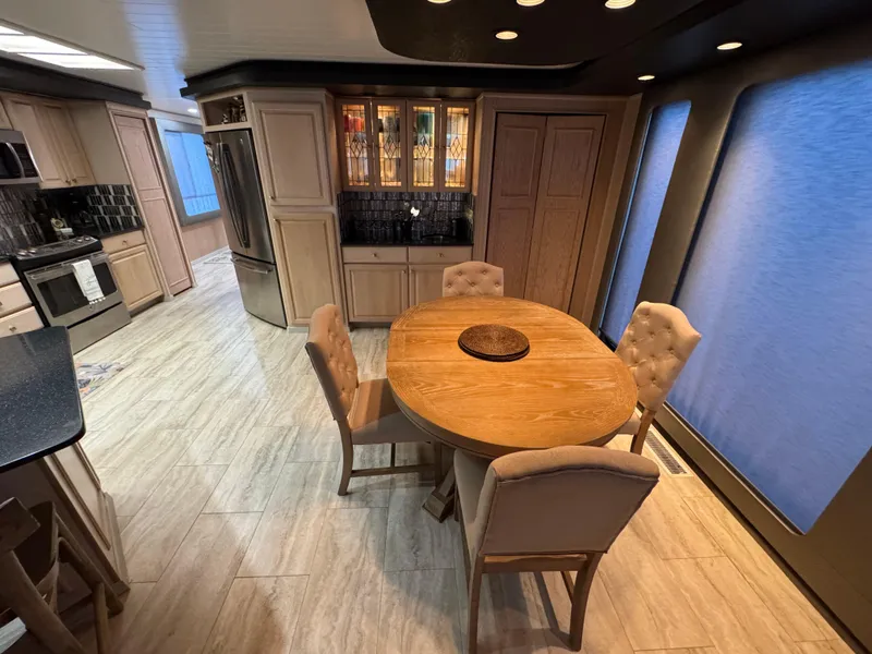 Slide: The Image of Luxurious dining area in a 1997 Sumerset 85x18 houseboat with modern kitchen. - 10