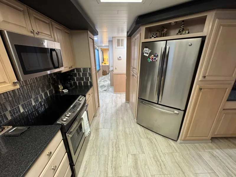 Slide: The Image of Modern kitchen in a 1997 Sumerset 85x18 houseboat with stainless steel appliances. - 13