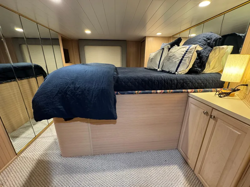 Slide: The Image of Bedroom interior of 1997 Sumerset 85x18 houseboat with mirrored closets and cozy bedding. - 17