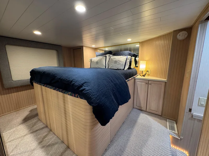 Slide: The Image of Cozy bedroom in 1997 Sumerset 85x18 houseboat with wood paneling and soft lighting. - 18