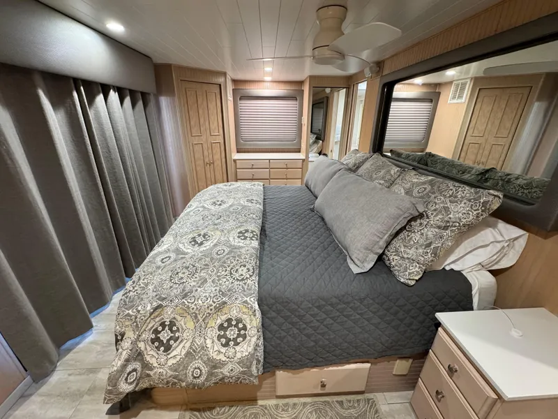 Slide: The Image of Luxurious bedroom interior of a 1997 Sumerset 85x18 houseboat with elegant bedding and wood accents. - 28