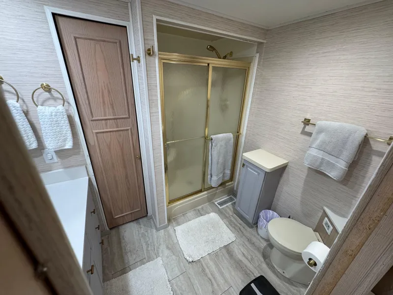 Slide: The Image of Bathroom in 1997 Sumerset 85x18 houseboat with shower, toilet, and towels. - 31