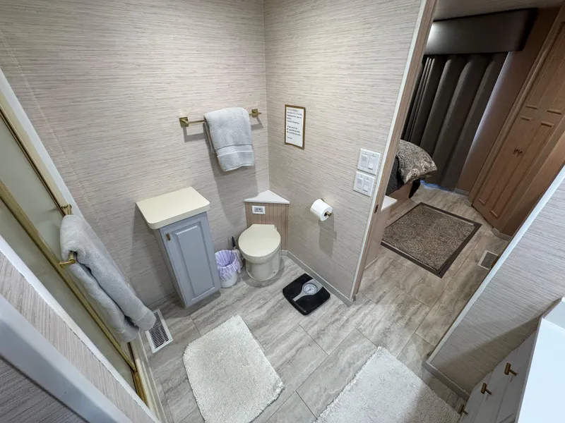 Slide: The Image of Bathroom interior of a 1997 Sumerset 85x18 houseboat, featuring modern decor and amenities. - 33