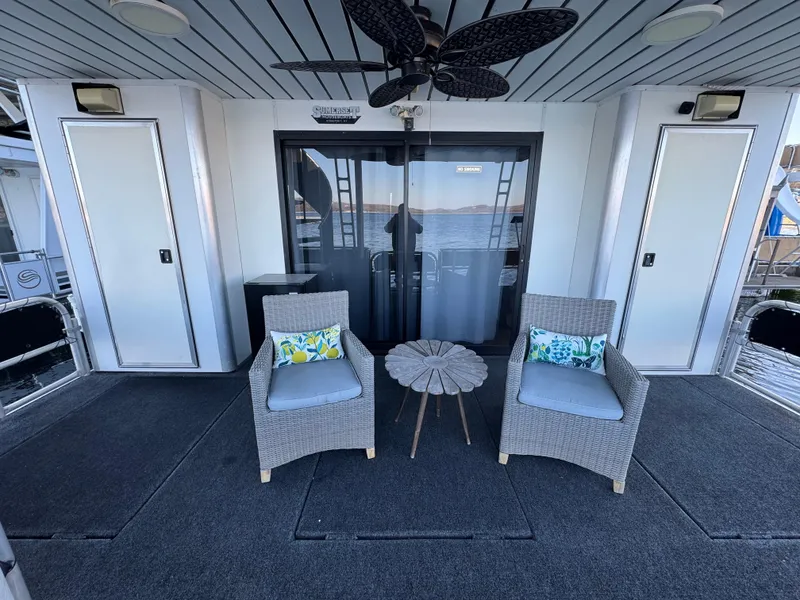 Slide: The Image of 1997 Sumerset 85x18 houseboat deck with wicker chairs and table. - 36