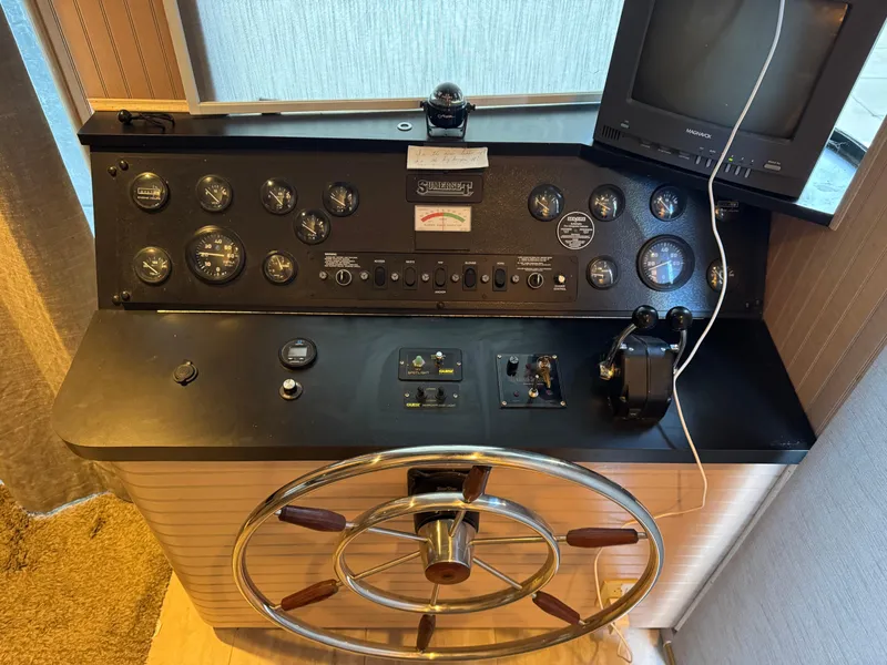 Slide: The Image of Control panel of a 1997 Sumerset 85x18 houseboat with steering wheel and gauges. - 38