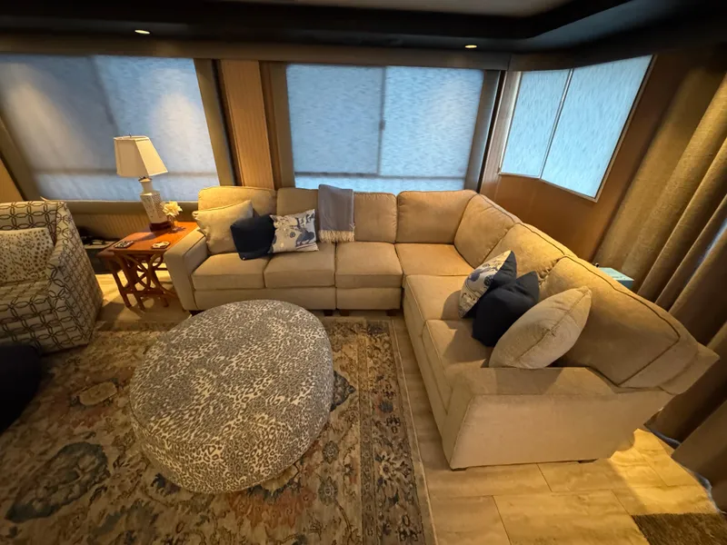 Slide: The Image of Cozy living area in 1997 Sumerset 85x18 houseboat with sectional sofa and patterned ottoman. - 6