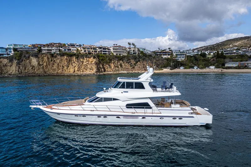 Slide: The Image of Johnson Pilothouse 70 Motor Yacht 2002 near coastal cliffs. - 17