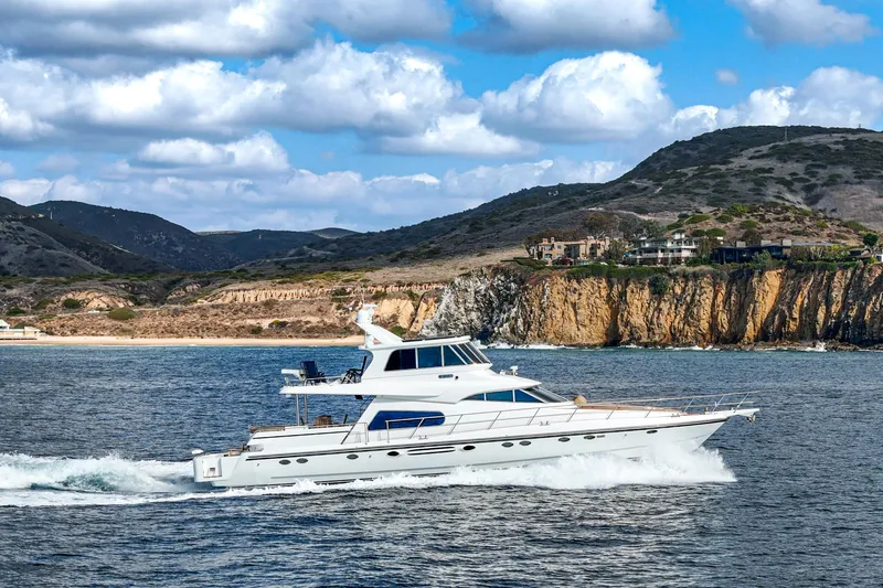 Slide: The Image of 2002 Johnson Pilothouse 70 Motor Yacht cruising on open water. - 19