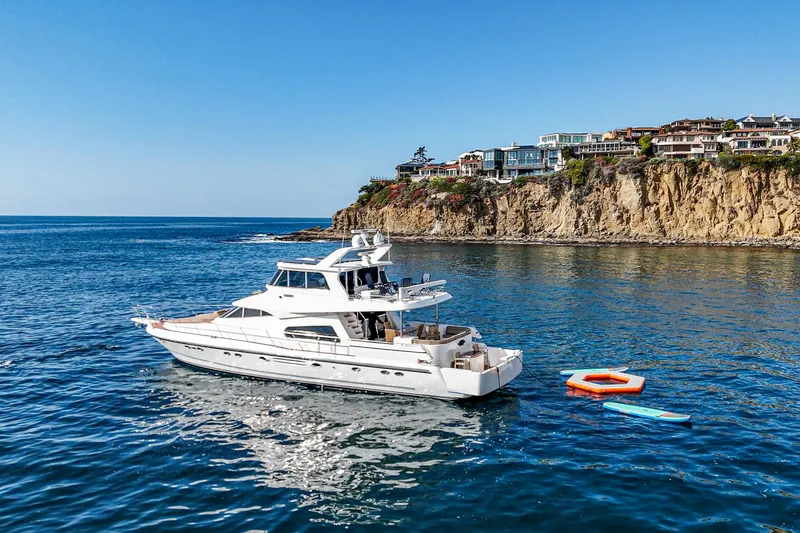 Slide: The Image of Johnson Pilothouse 70 Motor Yacht 2002 near coastal cliffs. - 22