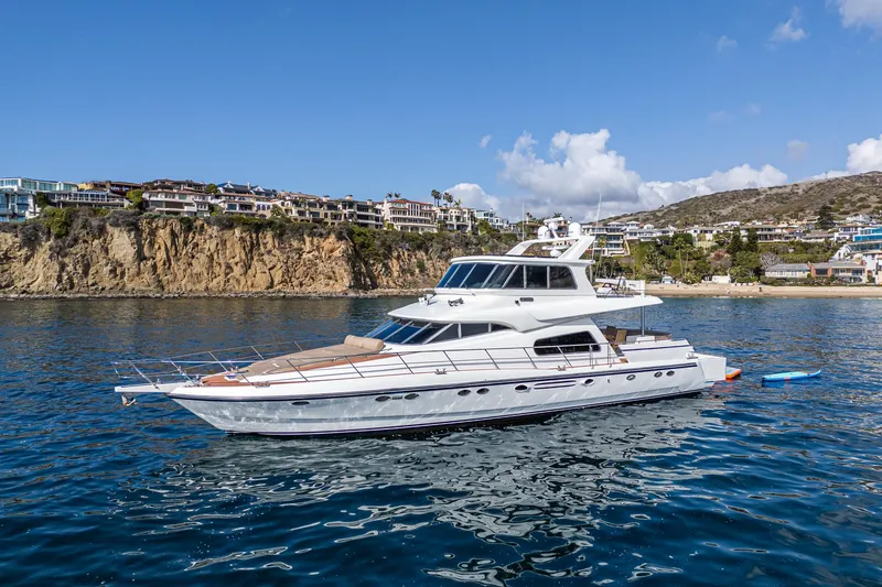 Slide: The Image of Johnson Pilothouse 70 Motor Yacht 2002 on calm water near coastline. - 23