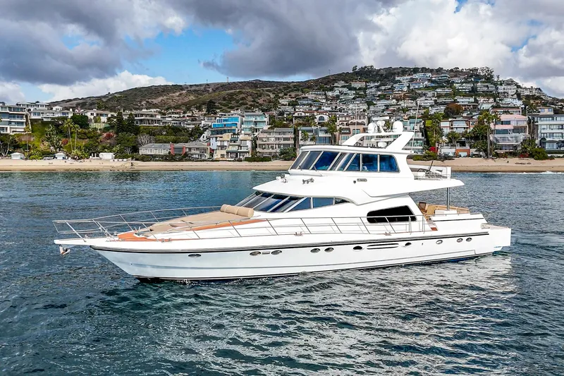 Slide: The Image of Johnson Pilothouse 70 Motor Yacht 2002 near coastal scenery. - 3