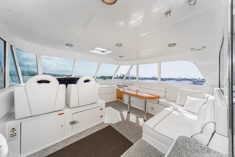 Slide: The Image of Interior of 2002 Johnson Pilothouse 70 Yacht with white seating. - 31