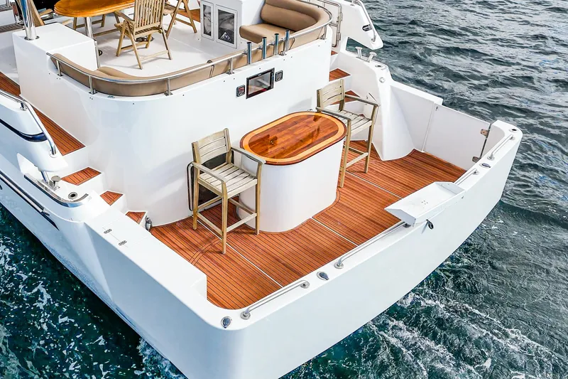 Slide: The Image of Deck of 2002 Johnson Pilothouse 70 Yacht with wooden furniture. - 39