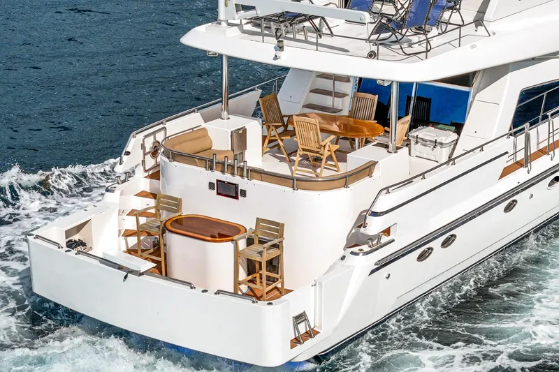 Slide: The Image of Johnson Pilothouse 70 Motor Yacht 2002 on water, luxurious deck design. - 4
