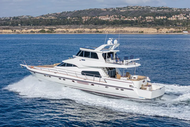 Slide: The Image of 2002 Johnson Pilothouse 70 Motor Yacht cruising on open sea. - 6