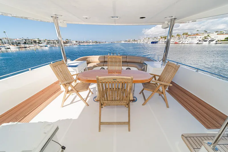 Slide: The Image of Deck of 2002 Johnson Pilothouse 70 Yacht with wooden furniture. - 9