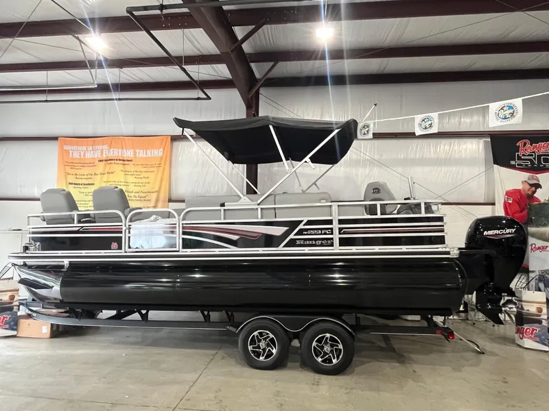 The Image of 2025 Ranger 223FC pontoon boat with canopy in indoor showroom. - 0