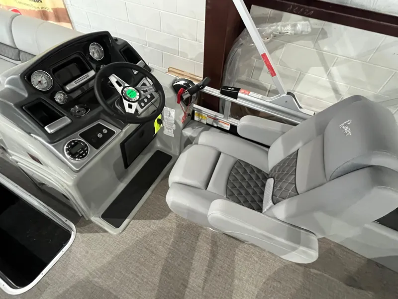 Slide: The Image of 2025 Ranger 223FC boat interior with steering console and cushioned seat. - 5