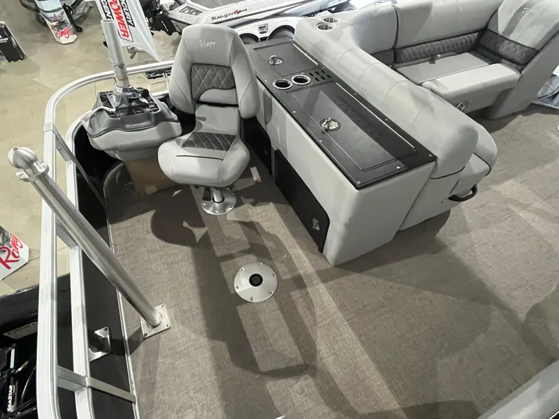 Slide: The Image of Interior of a 2025 Ranger 223FC boat with gray seating and console. - 6