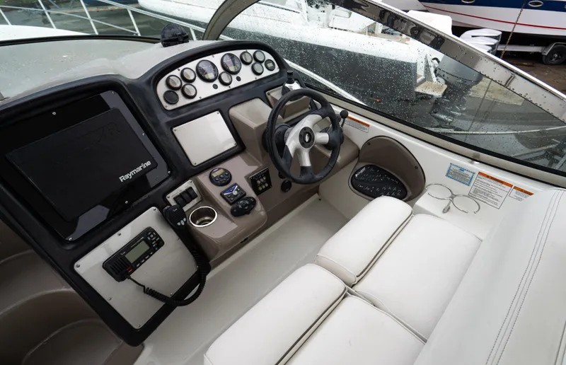 Slide: The Image of 2008 Cruisers 420 Express helm with steering wheel, controls, and navigation equipment. - 11