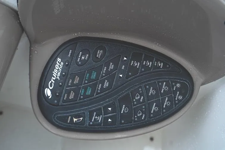 Slide: The Image of Control panel of a 2008 Cruisers 420 Express boat with various labeled buttons. - 15
