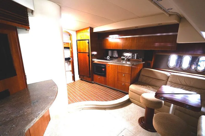 Slide: The Image of Interior of 2008 Cruisers 420 Express yacht with modern kitchen and seating area. - 17