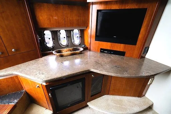 Slide: The Image of 2008 Cruisers 420 Express yacht interior with TV, countertop, and portholes. - 19