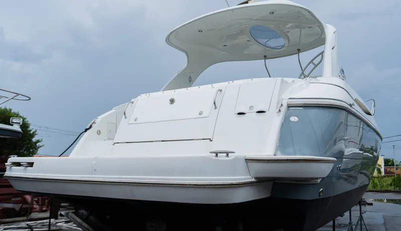 Slide: The Image of 2008 Cruisers 420 Express yacht, rear view, docked under cloudy sky. - 2