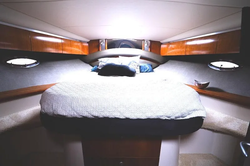 Slide: The Image of Luxurious cabin interior of 2008 Cruisers 420 Express yacht with cozy bed and wooden accents. - 21