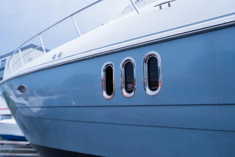 Slide: The Image of 2008 Cruisers 420 Express yacht, blue hull with chrome accents, docked. - 3