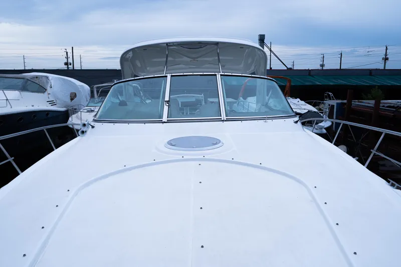 Slide: The Image of 2008 Cruisers 420 Express yacht, front view, docked under cloudy sky. - 4