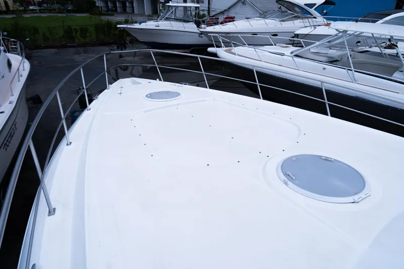 Slide: The Image of 2008 Cruisers 420 Express yacht docked with sleek white deck and railing. - 5