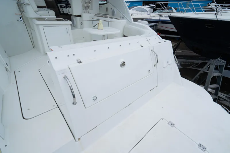 Slide: The Image of 2008 Cruisers 420 Express yacht deck with seating and storage compartments. - 9