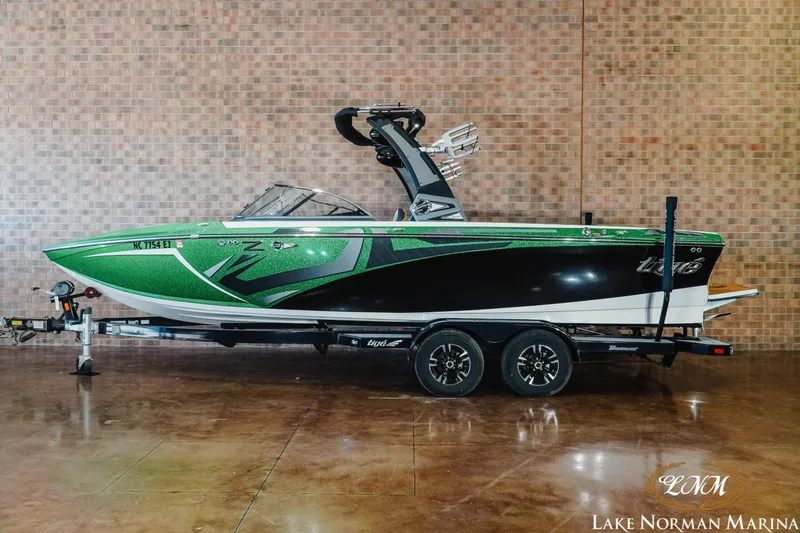 Slide: The Image of 2018 Tigé Z3 boat in green and black on trailer at Lake Norman Marina. - 0