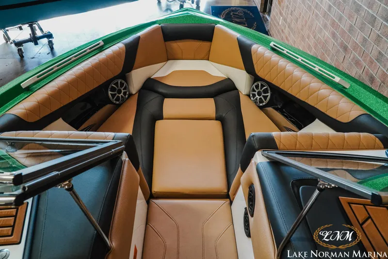 Slide: The Image of 2018 Tigé Z3 boat interior with tan and black seating, featuring speakers and stylish design. - 11