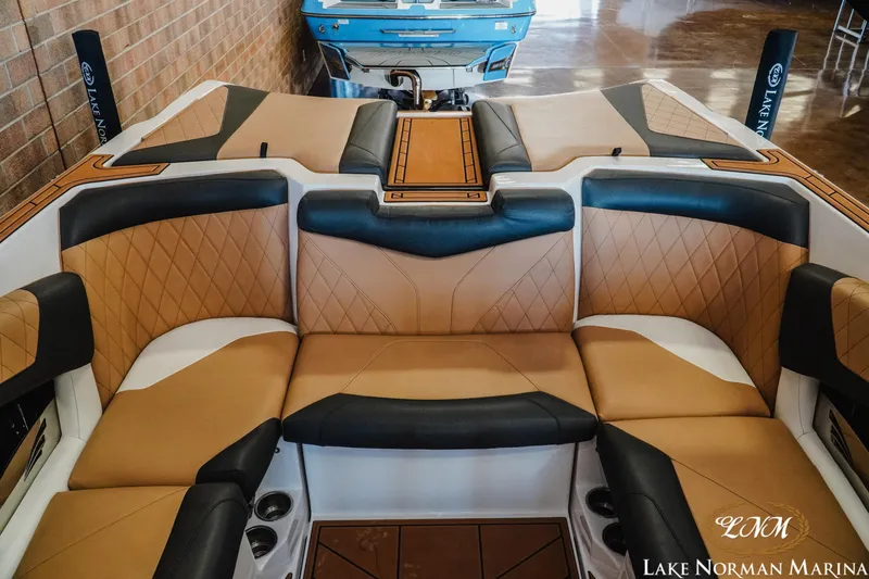 Slide: The Image of 2018 Tigé Z3 boat interior with tan and black seating at Lake Norman Marina. - 13