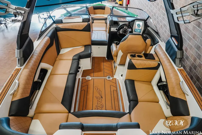 Slide: The Image of 2018 Tigé Z3 boat interior with tan and black seating, modern dashboard, and spacious layout. - 7