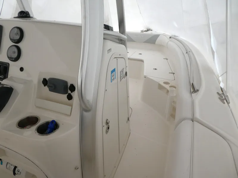 Slide: The Image of 2014 Boston Whaler 220 Outrage boat interior with console and seating area. - 10