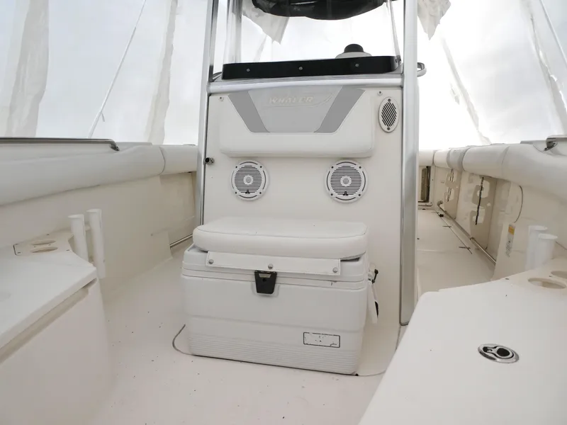 Slide: The Image of 2014 Boston Whaler 220 Outrage boat interior with seating and storage. - 12