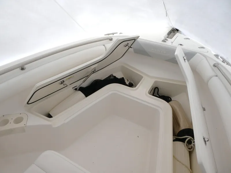 Slide: The Image of 2014 Boston Whaler 220 Outrage boat interior with open storage compartments. - 13