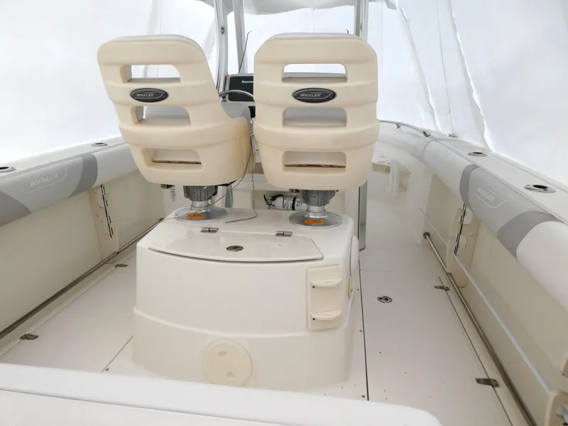 Slide: The Image of 2014 Boston Whaler 220 Outrage interior with dual seats and center console. - 3