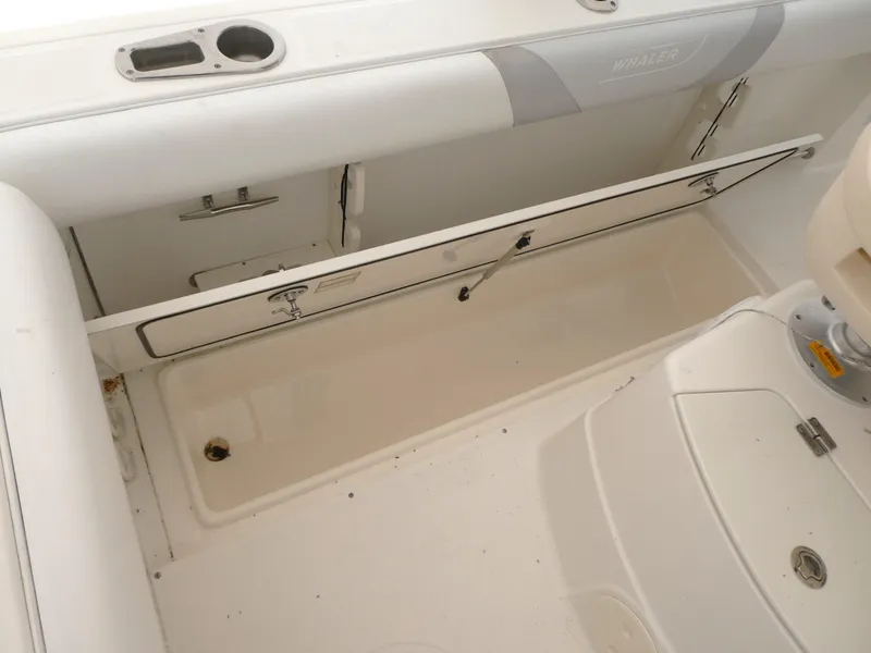 Slide: The Image of 2014 Boston Whaler 220 Outrage boat interior storage compartment. - 4