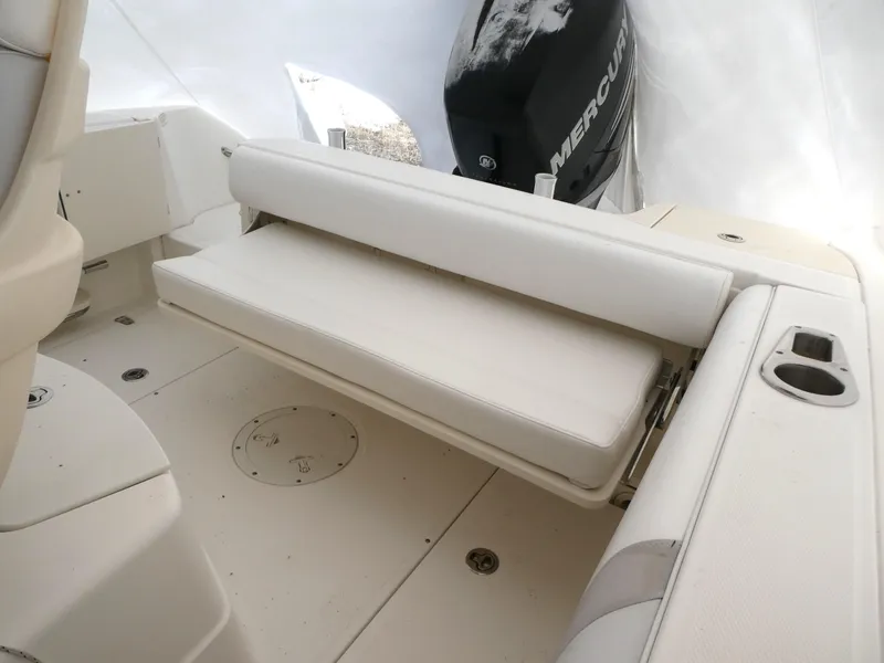 Slide: The Image of 2014 Boston Whaler 220 Outrage boat interior with foldable seating and Mercury engine. - 5