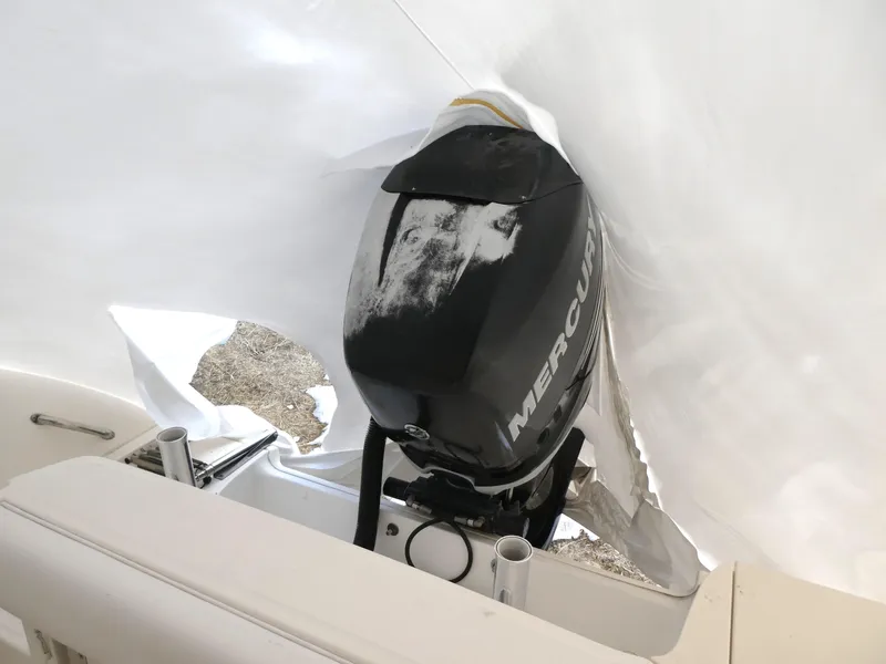 Slide: The Image of 2014 Boston Whaler 220 Outrage with Mercury outboard engine, partially covered. - 7