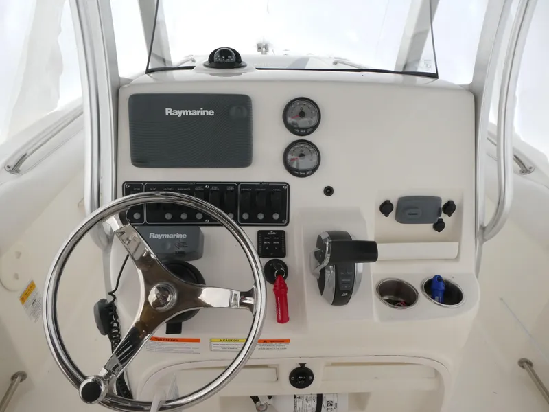 Slide: The Image of Boston Whaler 220 Outrage 2014 helm with Raymarine electronics and steering wheel. - 8