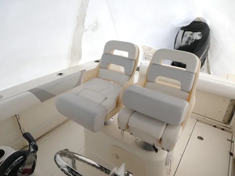 Slide: The Image of 2014 Boston Whaler 220 Outrage boat interior with dual cushioned seats. - 9